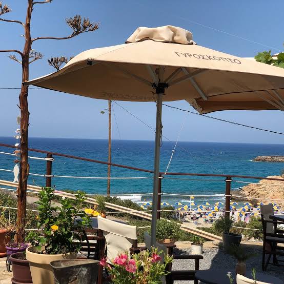 Gyroscopio parasol above the terrace with the beach and blue sea beyond